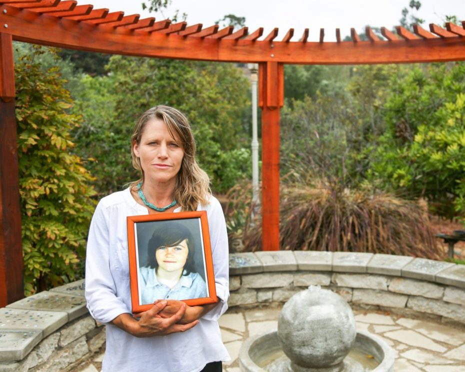 Katharine Prescott, holds a photo of her late son Kyler Prescott, in the memorial garden they created in his memory at their home in Vista, California September 21, 2016