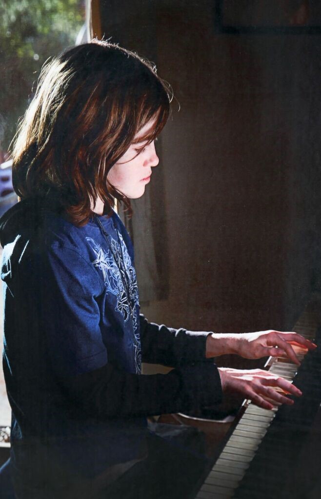Kyler Prescott sitting at a piano