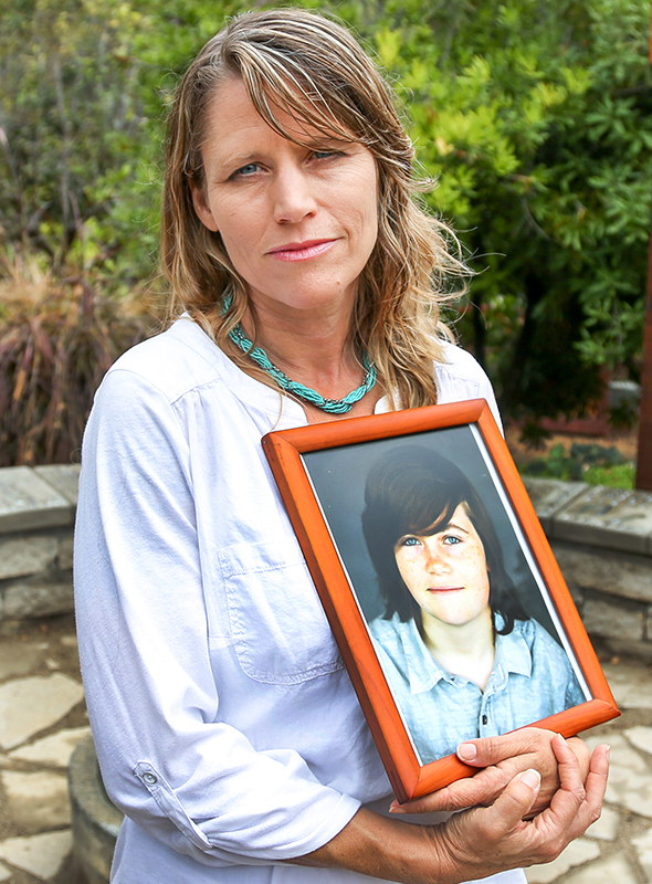 Katharine Prescott, holds a photo of her late son Kyler Prescott